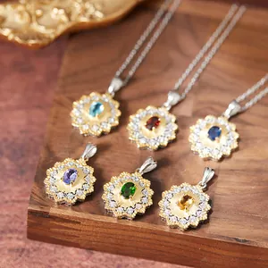 Close-up detail of floral sunburst pendants featuring natural topaz, sapphire, and garnet stones