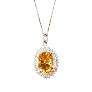 Close-up detail of a large oval yellow citrine pendant necklace with a sparkling halo