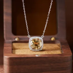 Macro view of cushion-cut citrine necklace pendant in sterling silver Diana style setting