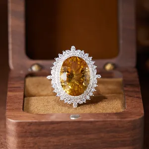Macro view of a large millennium cut citrine gemstone set in silver halo ring