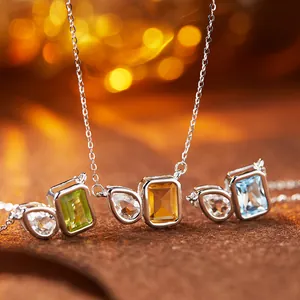 Close-up view of colorful natural gemstone necklaces with rectangular and teardrop pendants