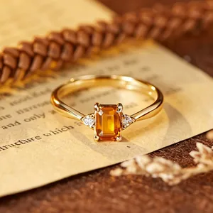 Macro detail of an emerald-cut yellow citrine ring crafted in gold-plated silver