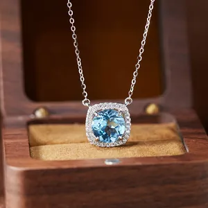 Macro detail of cushion-cut blue topaz pendant necklace with a sparkling gemstone halo