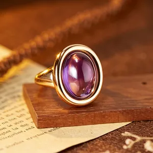 Close-up of elegant purple amethyst ring with polished gold-plated silver band