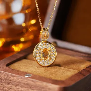 Detailed view of a gold-plated citrine pendant with S925 hallmark in a wooden box