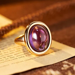Detailed close-up of a vintage amethyst gemstone ring with a 24K gold-plated silver setting.