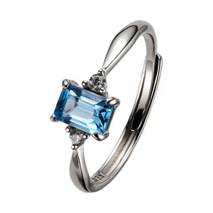 Elegant S925 sterling silver ring with an emerald-cut blue topaz and side stones