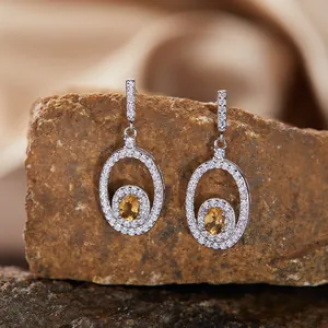 Close-up of elegant S925 silver oval earrings with sparkling citrine gemstones