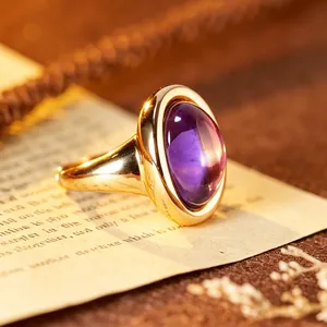 Exquisite close-up of an elegant purple amethyst bathtub ring with a luxurious 24K gold finish