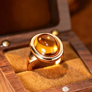 Macro view of natural citrine ring in 24K gold plated silver inside a wooden box