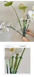 Detailed view of green plastic water tubes for floral preservation and orchid care.