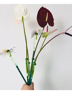 Detailed view of green flower water storage tubes with extension poles.
