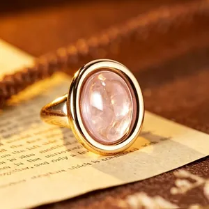Close-up of a vintage oval rose quartz ring with a 24K gold-plated silver setting.