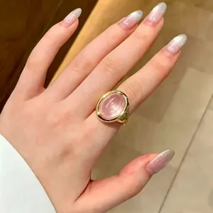Detail shot of a gold-plated bathtub ring featuring a large oval pink gemstone