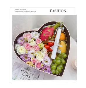 Detail view of heart-shaped gift box with flowers and fruits for Qixi festival