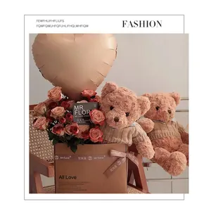 Heart-shaped foil balloon with roses and teddy bear in a gift box for celebrations
