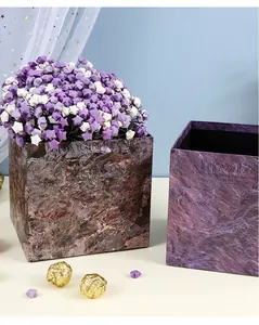 Close-up detail of the elegant plum purple marble pattern on square nested gift boxes
