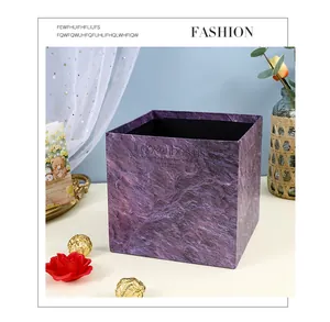 Macro detail view of purple marble textured square flower gift box in a gift setting