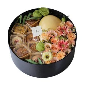 Luxury round black gift box filled with mooncakes and beautiful fresh flowers