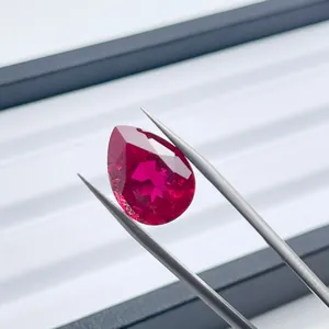 Macro view of a pear-shaped lab-grown ruby featuring fine internal silk inclusions