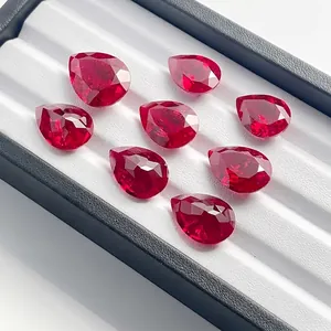 Macro view of pear-cut lab-grown rubies with brilliant facets in a jewelry box