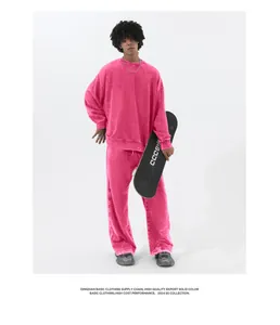 Ganzkörperansicht eines Mannes in pinkfarbenem gewaschenem Vintage-Sweatshirt und Hose