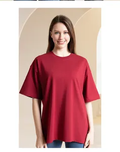 Front view of a loose-fitting red heavyweight cotton T-shirt on a smiling female model.