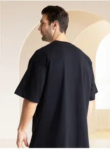 Back view of a premium 300g heavyweight pure cotton oversized black t-shirt on a model