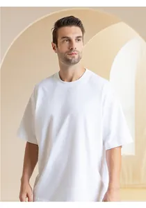 Detail of a heavyweight 300g white cotton t-shirt with a loose crew neck fit.