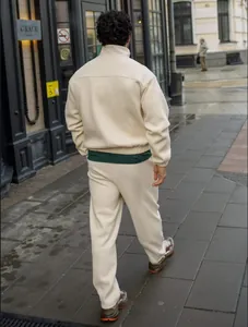 Back view of men's cream ribbed tracksuit featuring zip-up jacket and matching pants