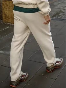 Detailed side view of beige ribbed joggers for men showing fabric texture and casual fit