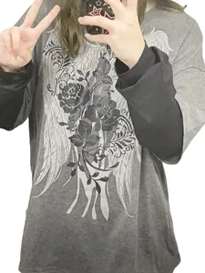 Close-up of a grey fake two-piece long sleeve T-shirt with a graphic wing print