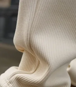Close-up detail of soft cream-colored ribbed knit fabric for men's casual set