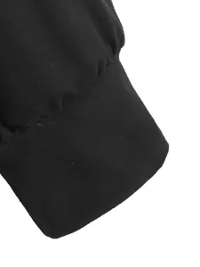 Close-up detail of the sleeve cuff on a black long-sleeved shirt with a clean finish.