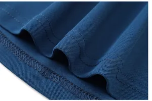 Macro view of blue pique polo shirt fabric showing breathable honeycomb texture and stitching