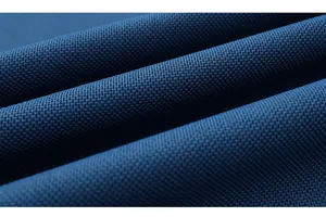 Macro close-up of dark blue piqué fabric showing breathable texture and knit details