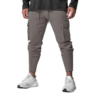 Close-up of men's grey cargo joggers showing multi-pocket design and ribbed cuff texture