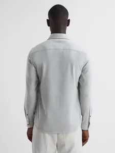 Back view of a grey casual men's shirt jacket featuring textured fabric detail.