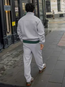Back view of men's gray ribbed tracksuit set including stand-collar jacket and pants