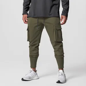 Detail of olive green men's cargo joggers with large side pockets and ribbed cuffs