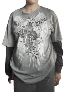 Front view of oversized false two-piece long sleeve tee with gothic wing graphic