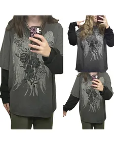 Detail view of the oversized gothic wing and floral print on a layered-look T-shirt.