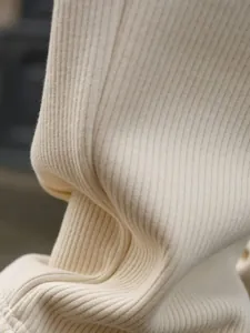Detail shot of premium beige ribbed knit fabric for men's thermal winter track suit