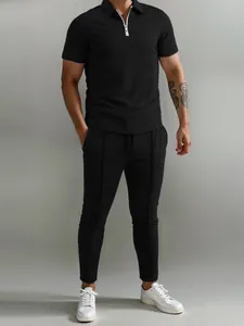 Detailed view of men's black 2-piece casual set featuring polo shirt and pants outfit