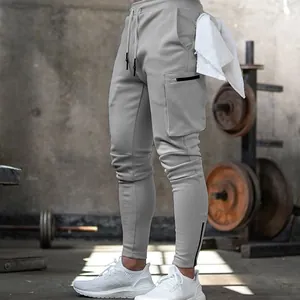 Men's slim fit athletic gym joggers with cargo zip pockets in a stylish light grey