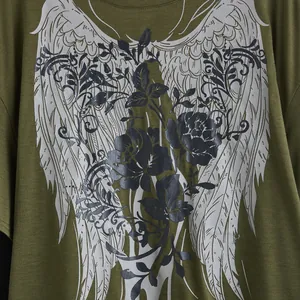 Detail view of the intricate wing and rose floral print on an olive green T-shirt.