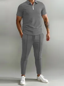 Men's grey casual two-piece set featuring a zip polo shirt and matching trousers