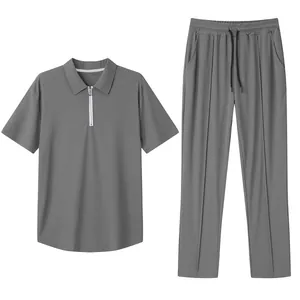Detailed view of grey men's pique polo shirt and pants casual two-piece set.