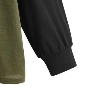 Close-up of black ribbed cuff and olive green jersey fabric on a casual long sleeve top