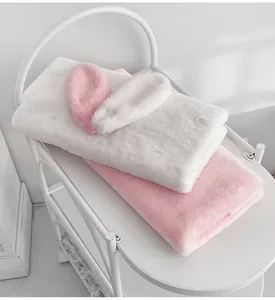 Soft pink and white plush rabbit ears and fabric material for DIY bouquet wrapping